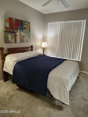 a bedroom with a bed and window