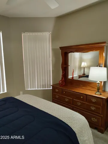 a bedroom with a bed and window