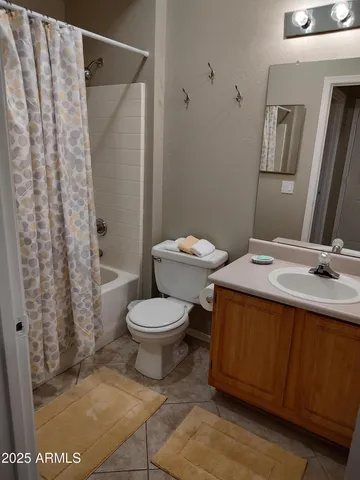 a bathroom with a toilet sink and shower