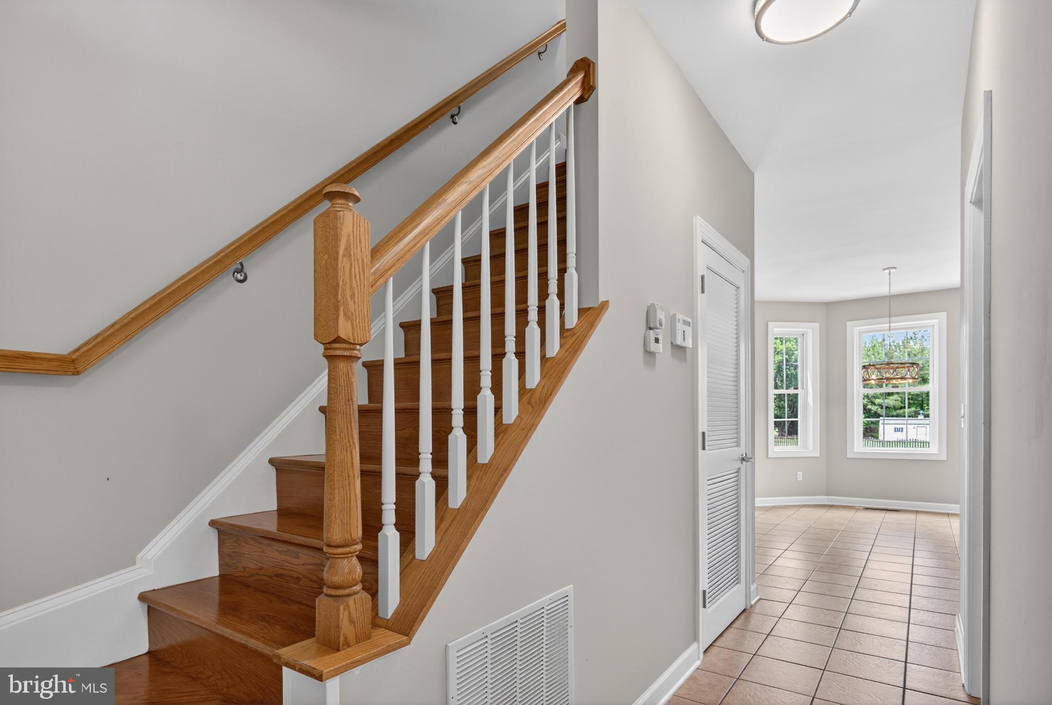 337 Roe Ingleside Road Centreville, MD 21617 - Photo 14 of 56 a view of staircase with lots of frames on wall and windows