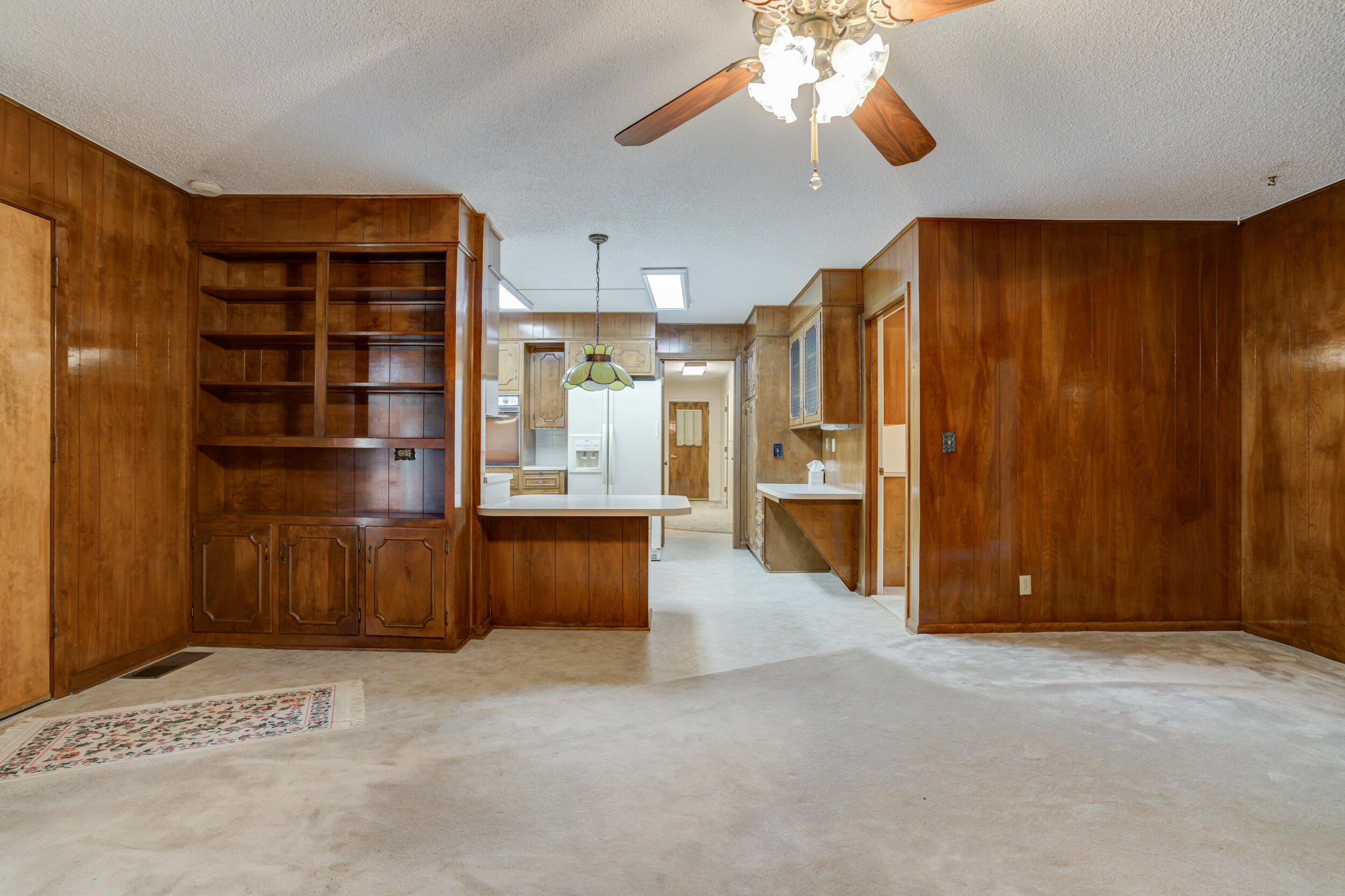 509 18th Street Seagraves, TX 79359 - Photo 11 of 25 a view of an empty room with a cabinet and a flat screen tv