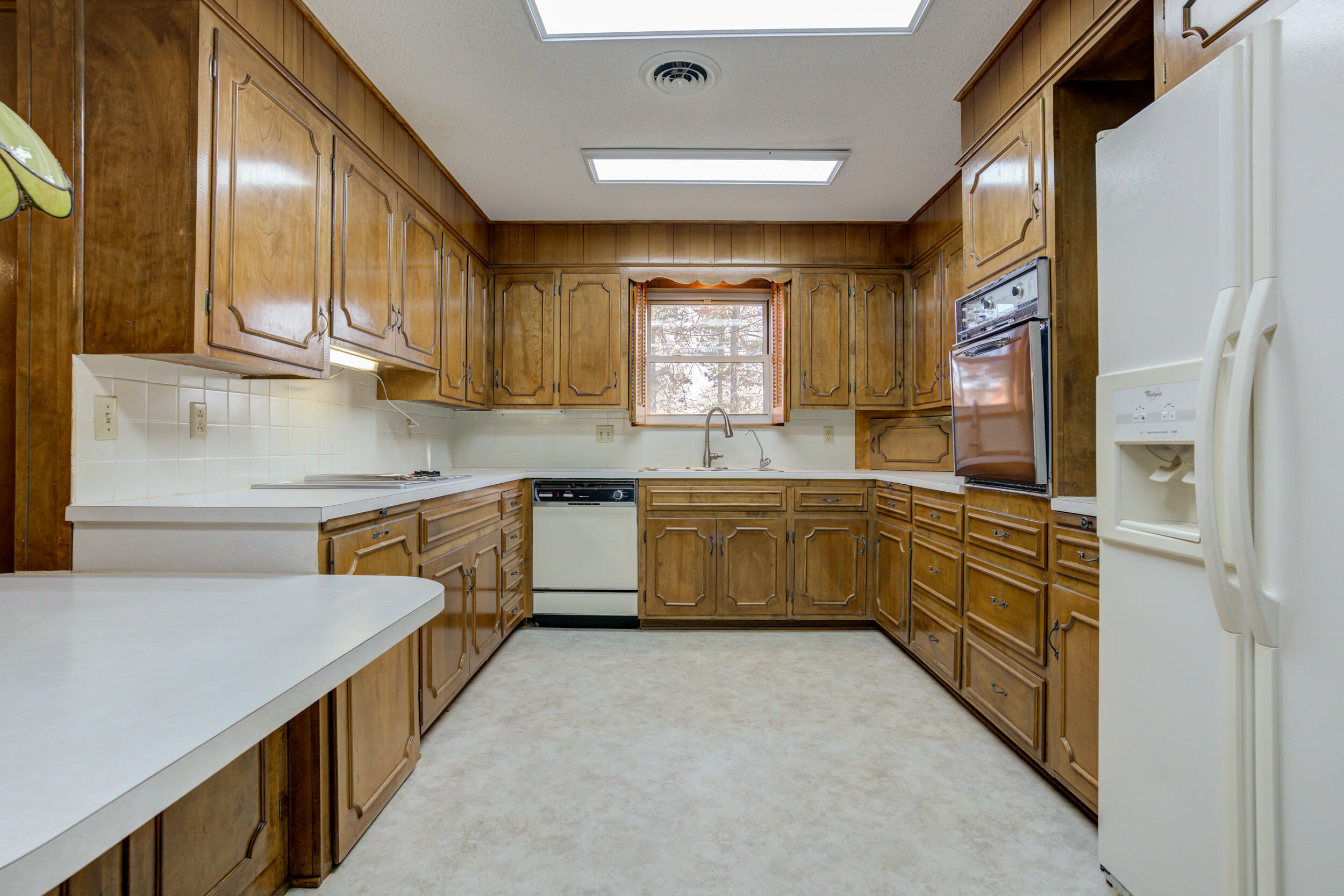 509 18th Street Seagraves, TX 79359 - Photo 14 of 25 a kitchen with stainless steel appliances sink cabinets and window