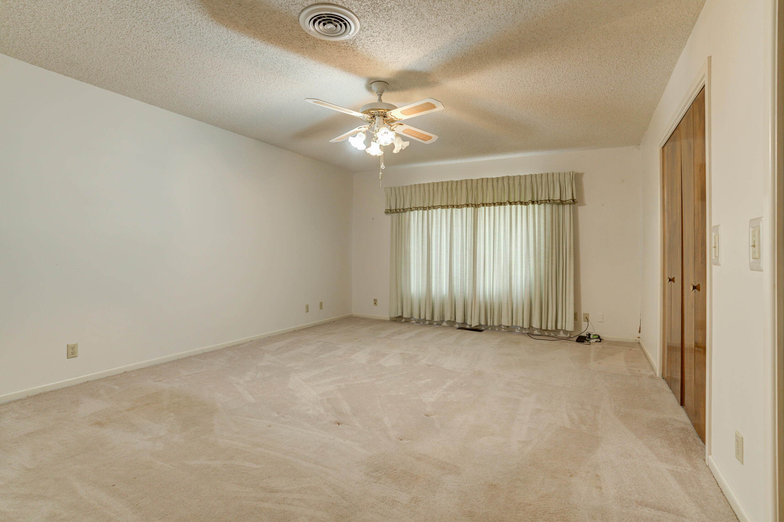 509 18th Street Seagraves, TX 79359 - Photo 16 of 25 an empty room with fan and windows