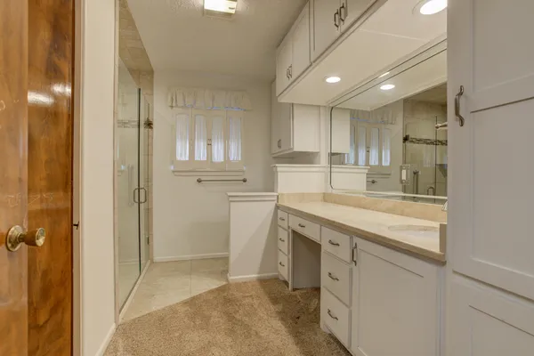 a bathroom with a granite countertop sink mirror and double