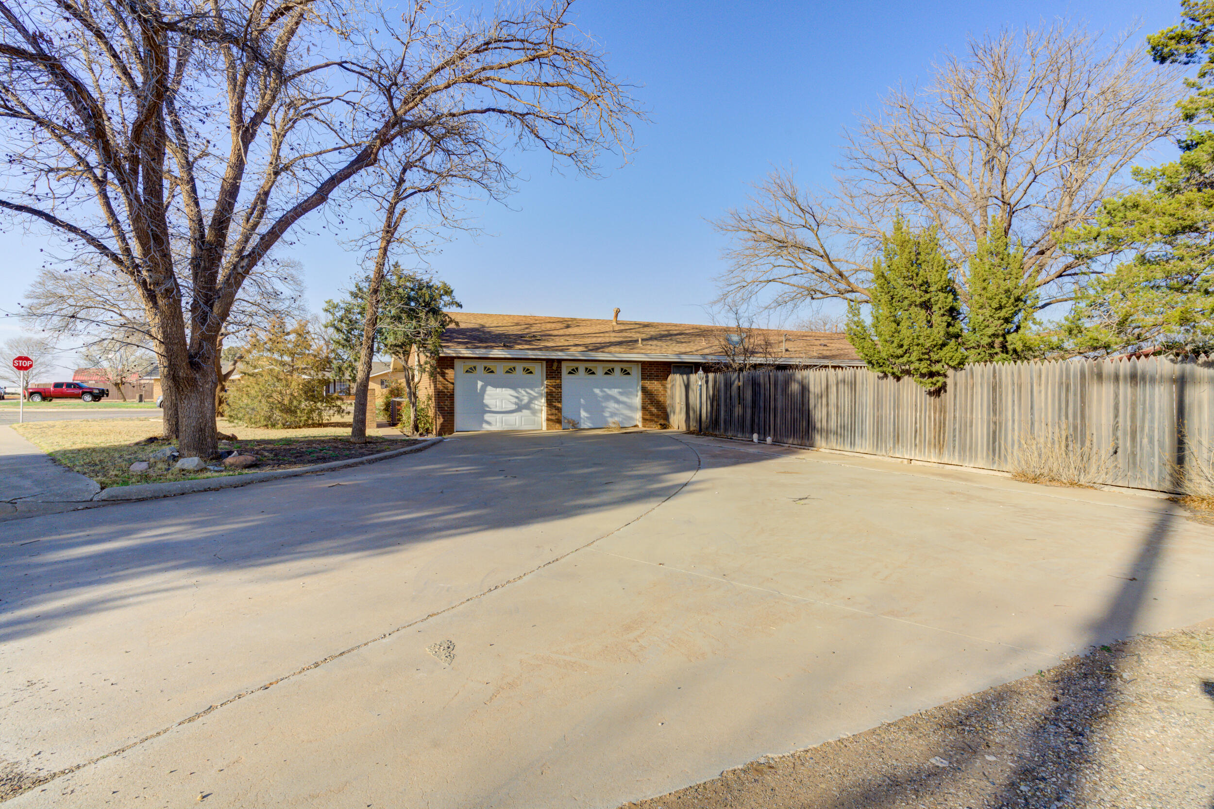 509 18th Street Seagraves, TX 79359 - Photo 2 of 25 a front view of a house with a yard and garage