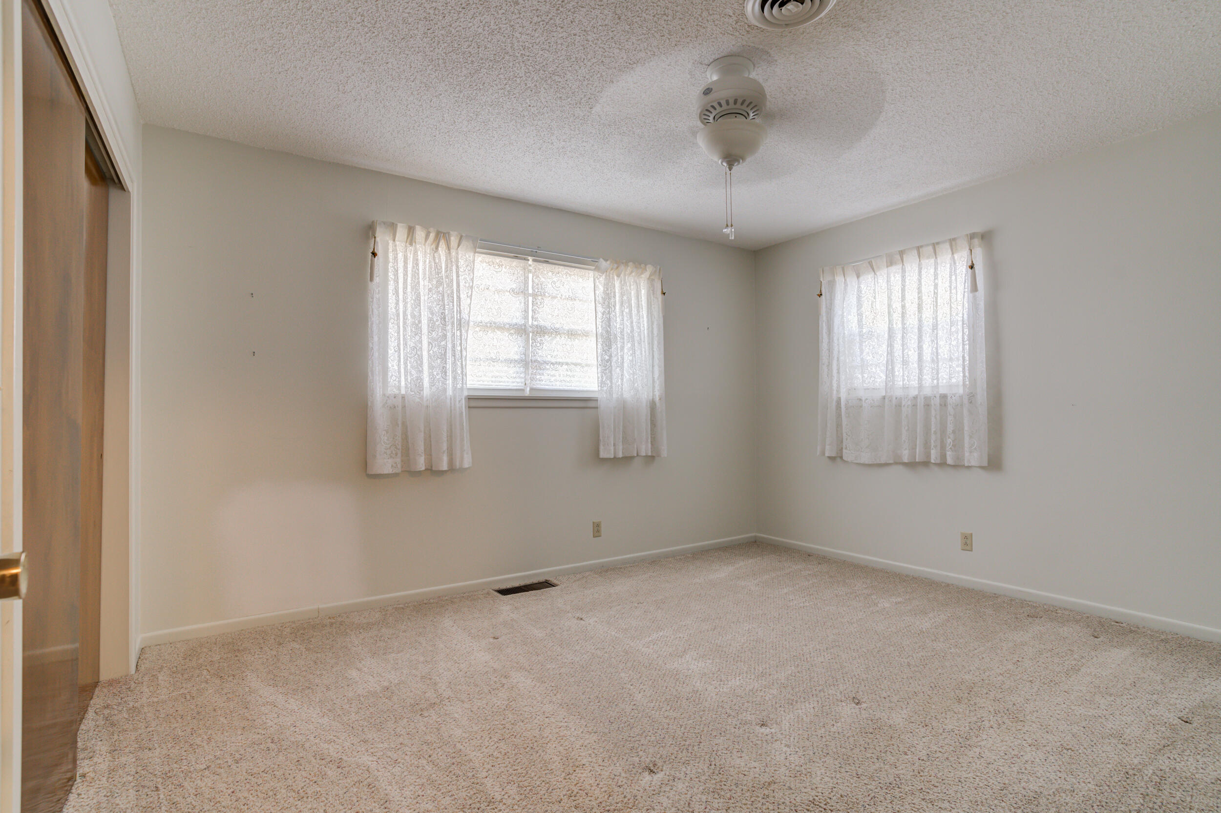 509 18th Street Seagraves, TX 79359 - Photo 24 of 25 an empty room with windows