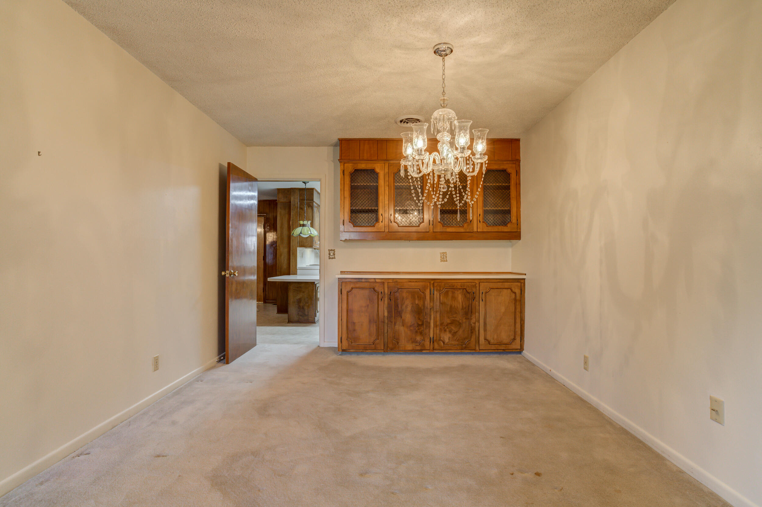 509 18th Street Seagraves, TX 79359 - Photo 8 of 25 a view of a big room with windows and chandelier