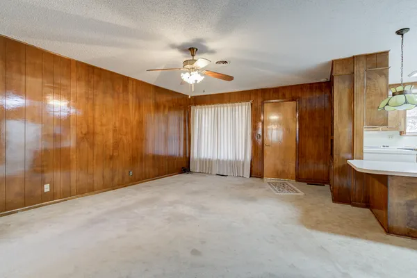 a view of empty room with ceiling fan