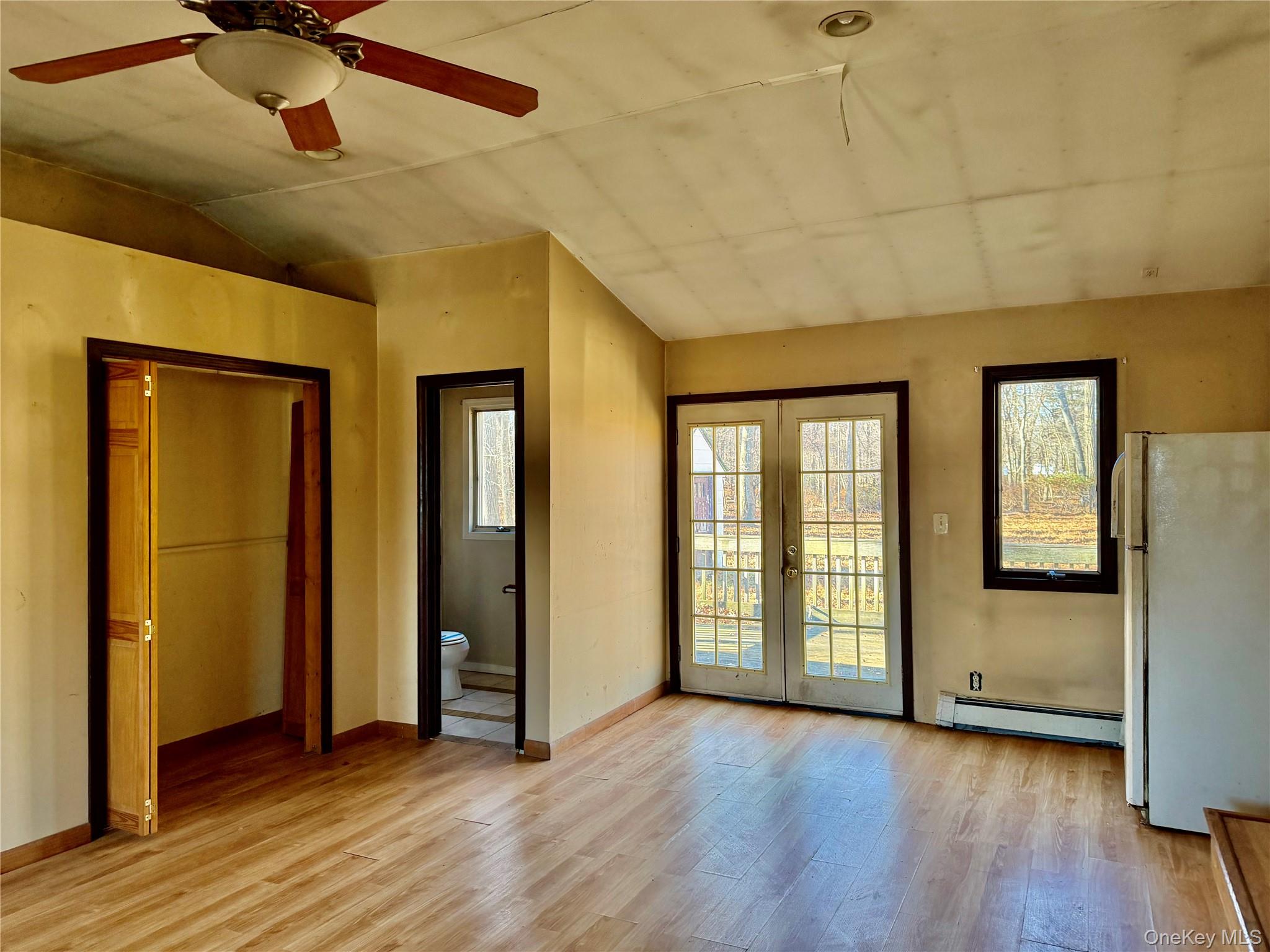 26 North Swezeytown Road Middle Island, NY 11953 - Photo 13 of 27 a view of an empty room with window and wooden floor