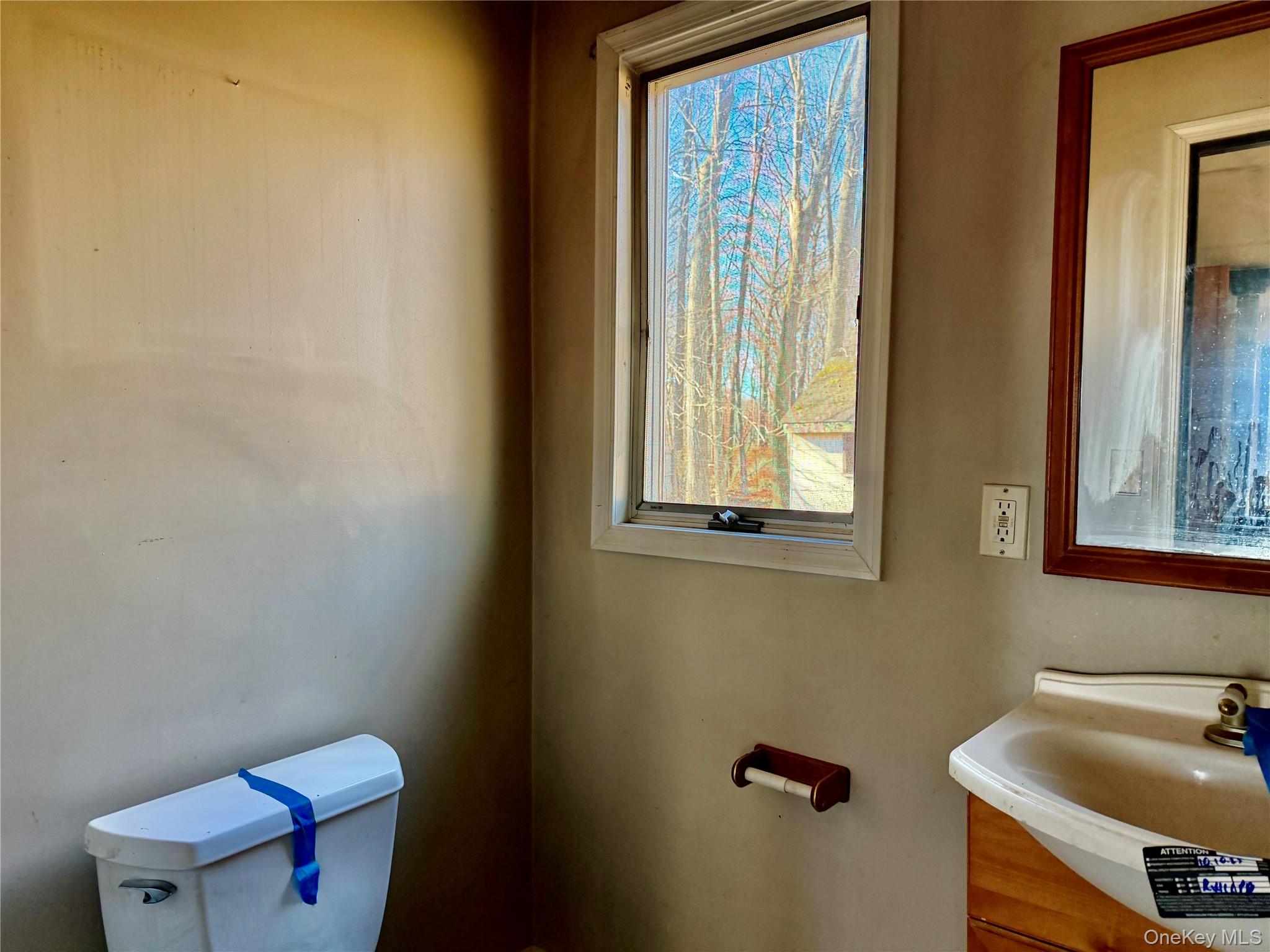 26 North Swezeytown Road Middle Island, NY 11953 - Photo 14 of 27 a bathroom with a sink and a toilet