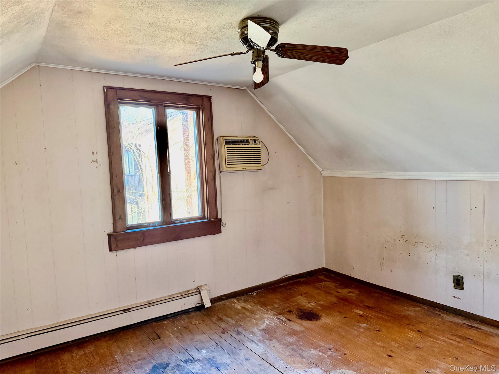 26 North Swezeytown Road Middle Island, NY 11953 - Photo 17 of 27 a view of empty room with wooden floor and fan