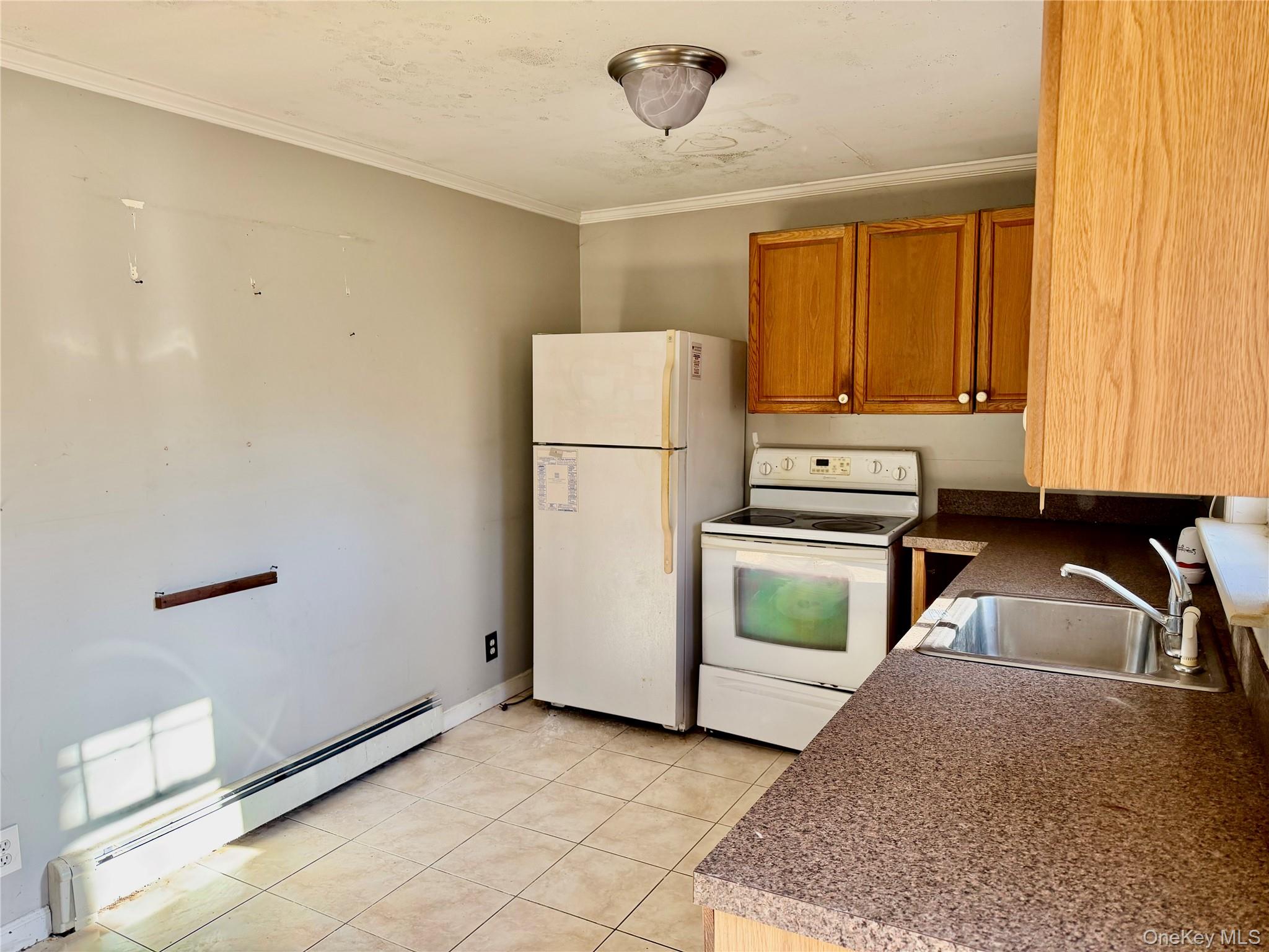 26 North Swezeytown Road Middle Island, NY 11953 - Photo 20 of 27 a kitchen with a refrigerator and a sink