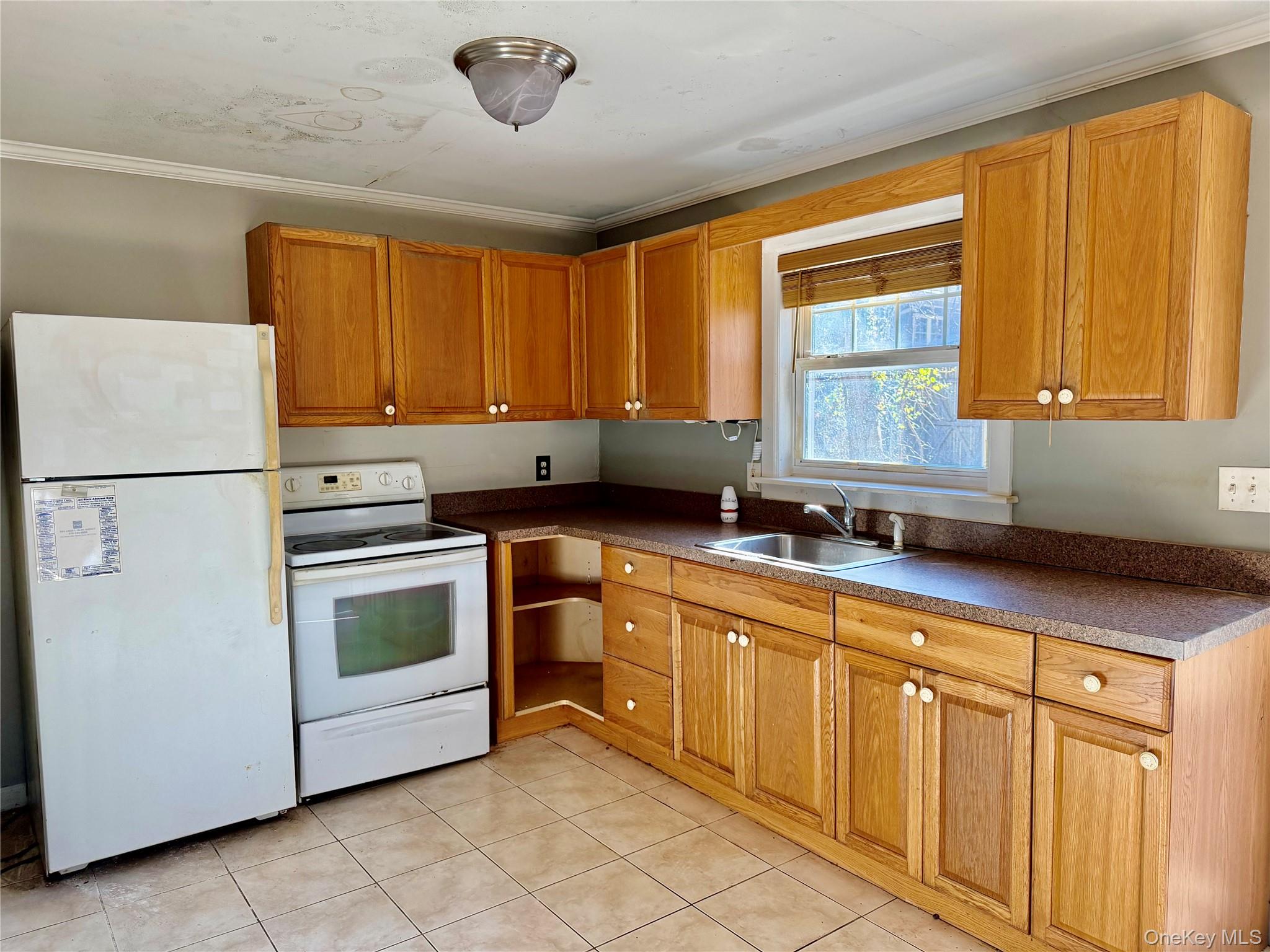 26 North Swezeytown Road Middle Island, NY 11953 - Photo 21 of 27 a kitchen with stainless steel appliances granite countertop a refrigerator sink and cabinets