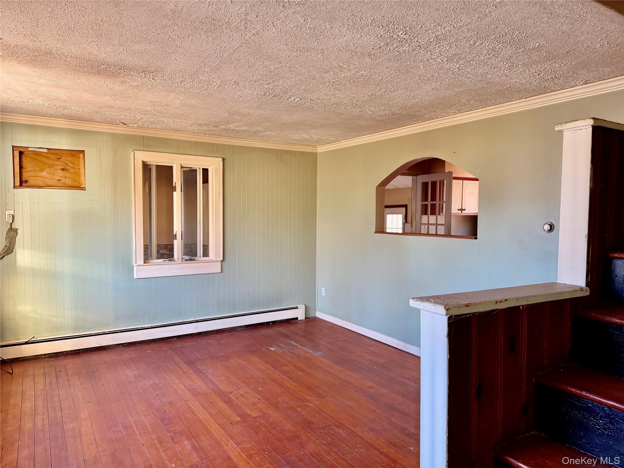 26 North Swezeytown Road Middle Island, NY 11953 - Photo 4 of 27 a view of a livingroom with wooden floor and a window