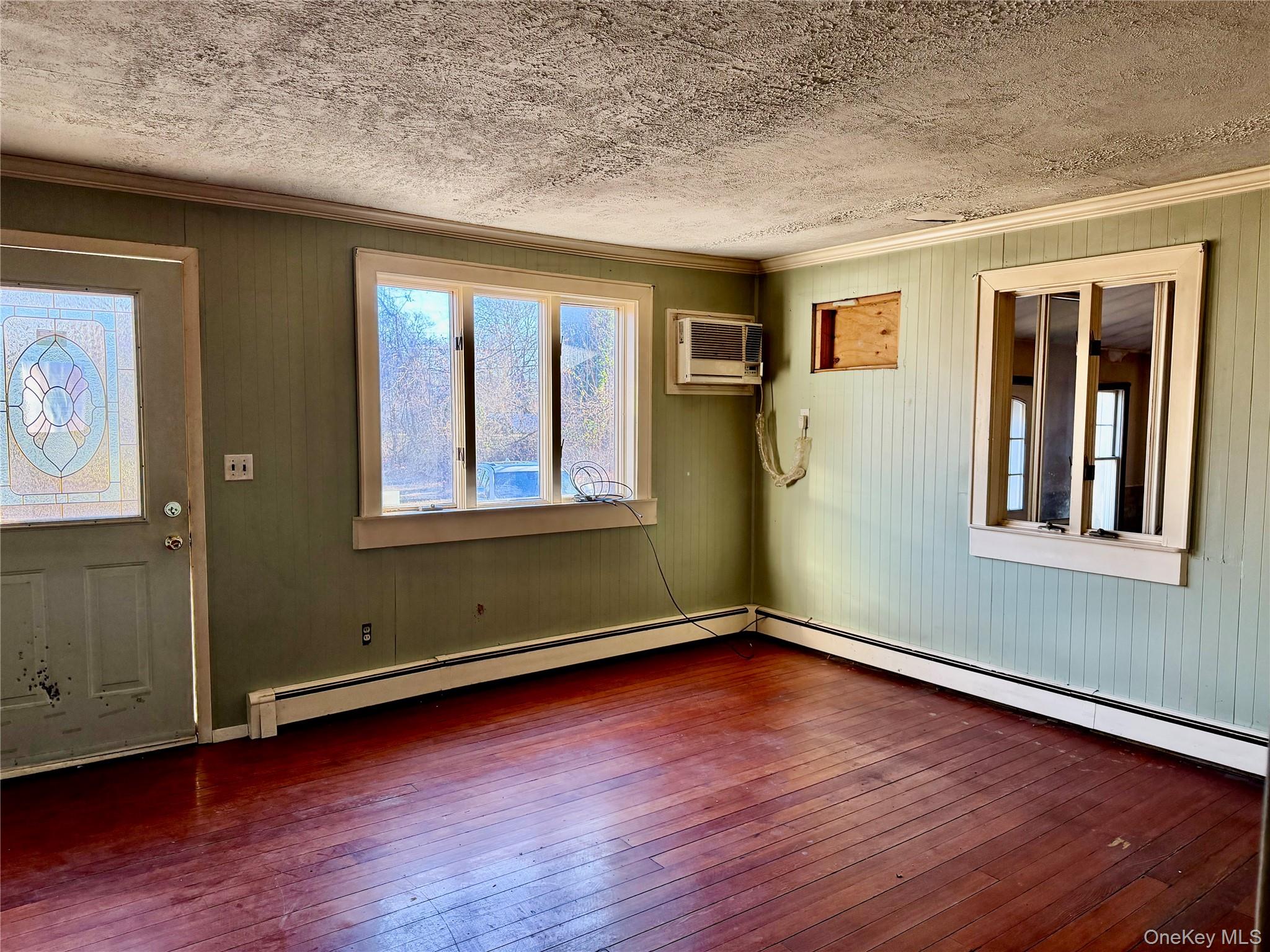 26 North Swezeytown Road Middle Island, NY 11953 - Photo 6 of 27 an empty room with wooden floor and windows