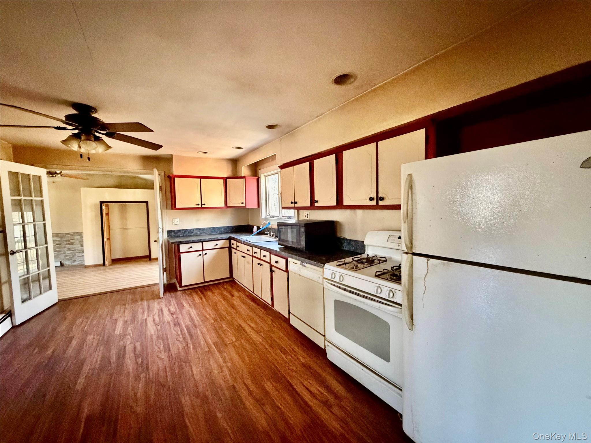 26 North Swezeytown Road Middle Island, NY 11953 - Photo 7 of 27 a kitchen with stainless steel appliances a refrigerator sink and microwave