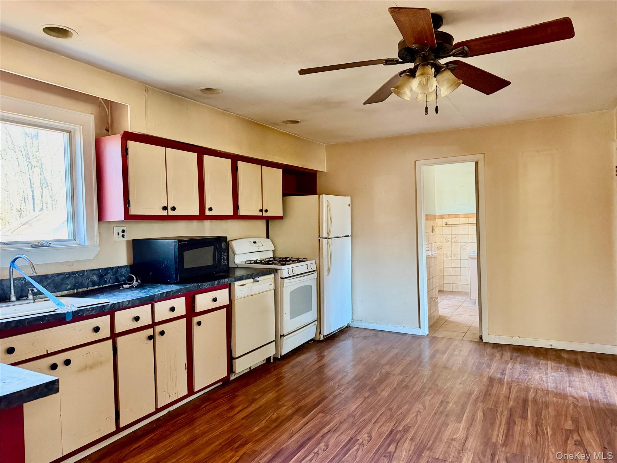 26 North Swezeytown Road Middle Island, NY 11953 - Photo 8 of 27 a kitchen with granite countertop a stove a sink and a refrigerator