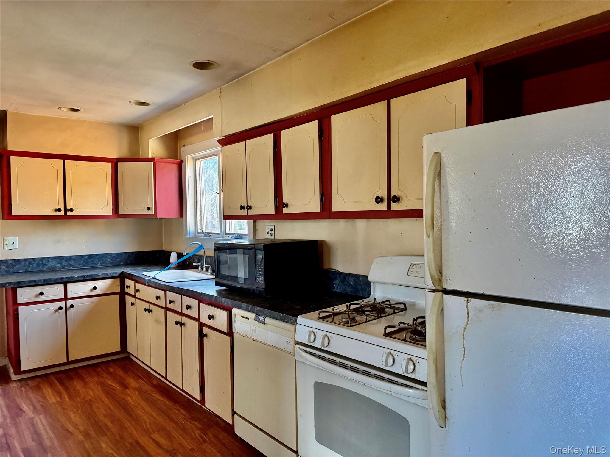 26 North Swezeytown Road Middle Island, NY 11953 - Photo 9 of 27 a kitchen with a stove a sink and a refrigerator