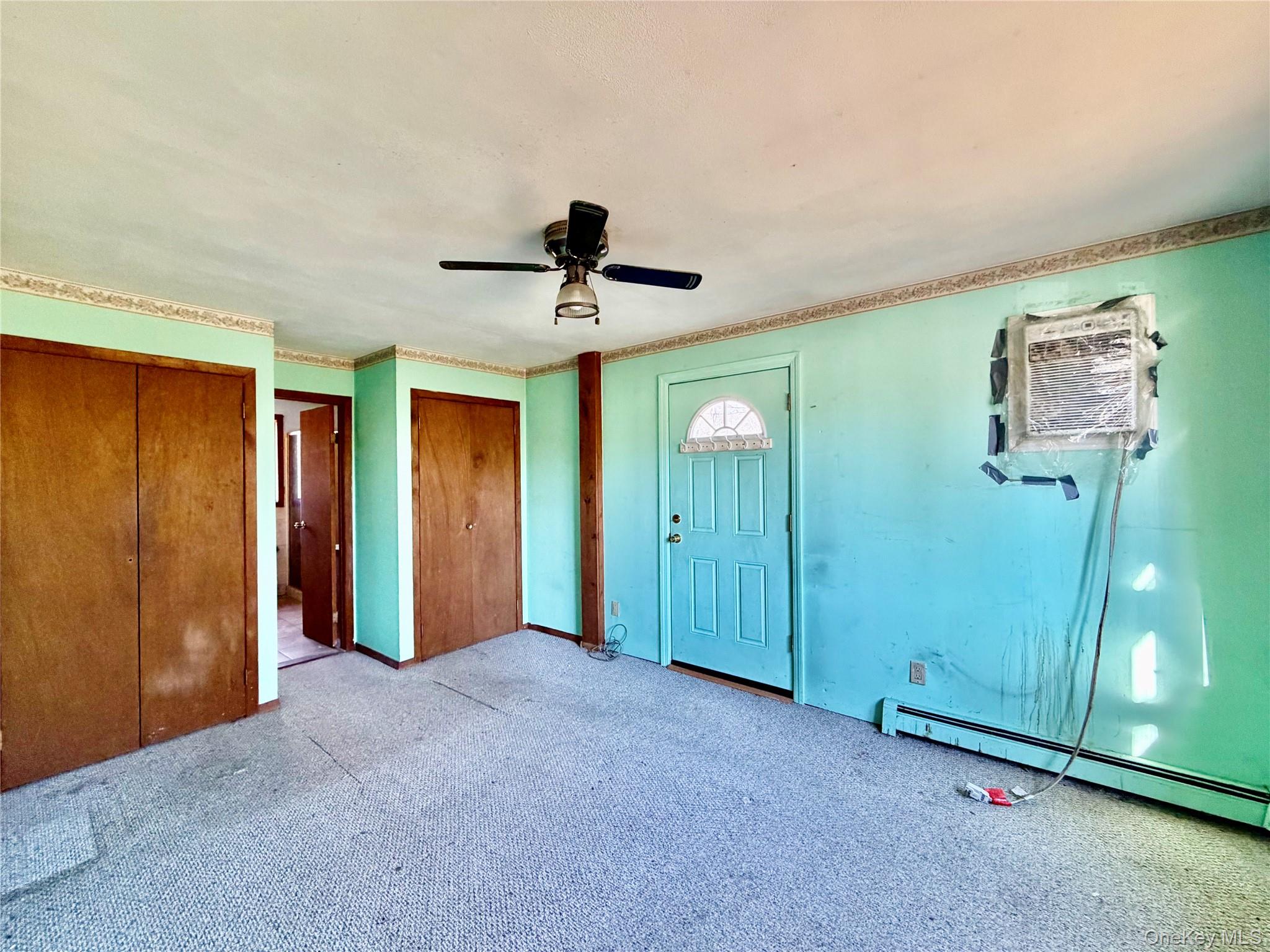 26 North Swezeytown Road Middle Island, NY 11953 - Photo 10 of 27 a view of a livingroom with a chandelier fan and windows