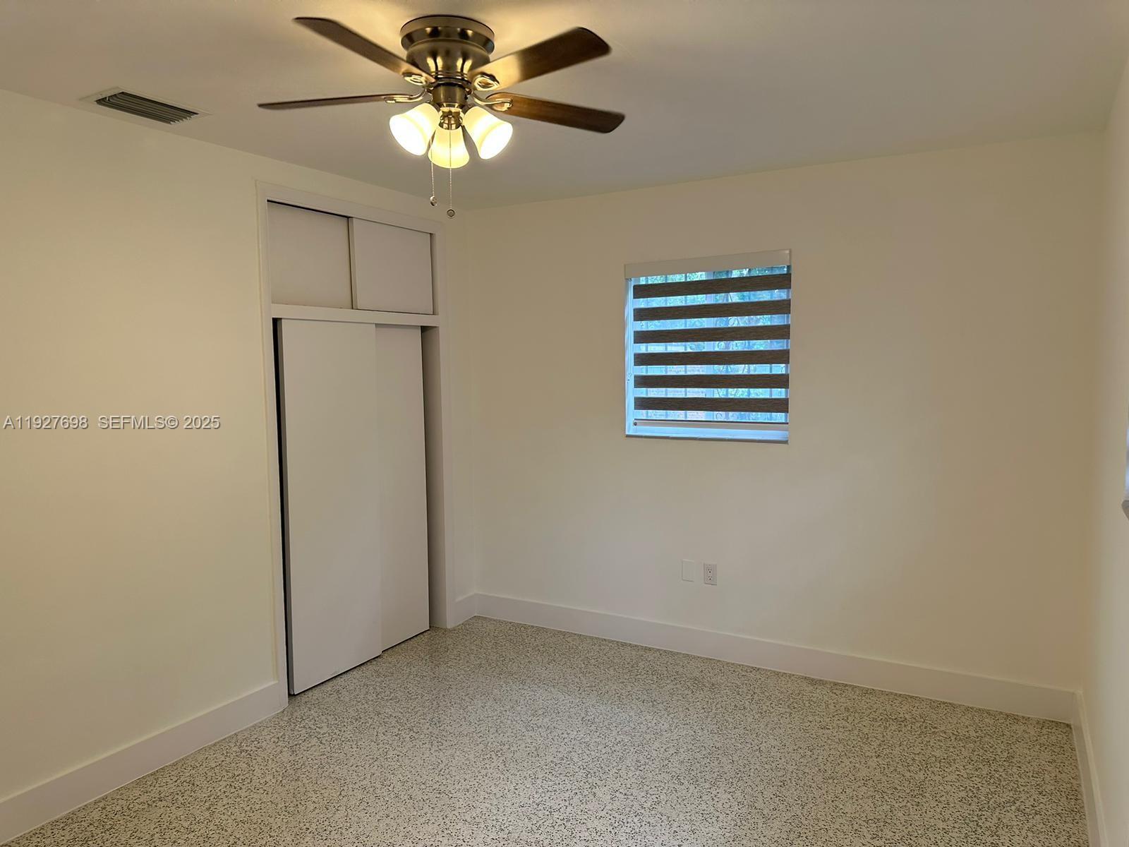 7071 Southwest 4th Street, Unit 2 Miami, FL 33144 - Photo 12 of 27 an empty room with windows and fan