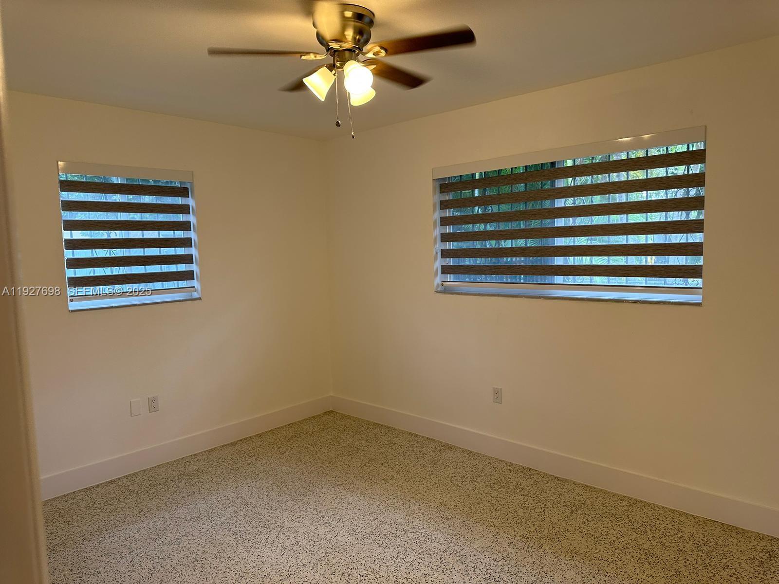 7071 Southwest 4th Street, Unit 2 Miami, FL 33144 - Photo 13 of 27 an empty room with a view of ceiling fan