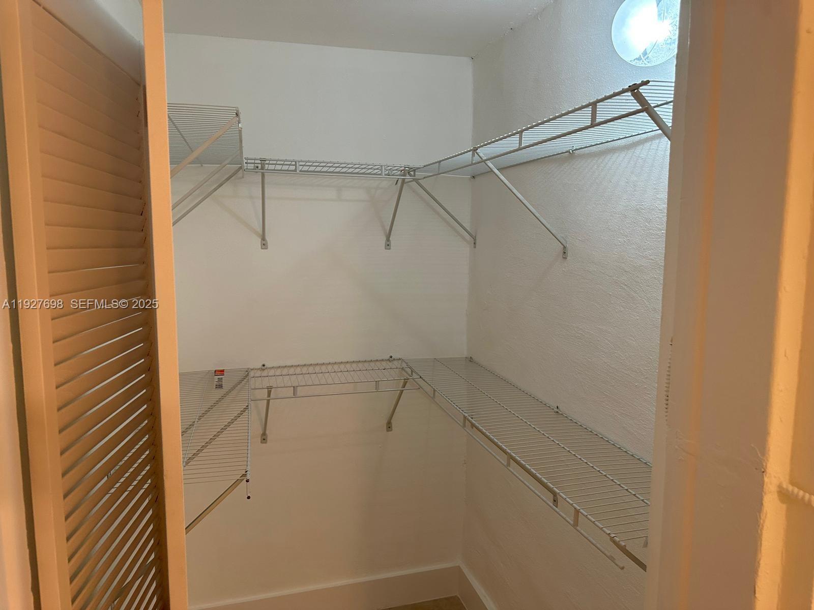 7071 Southwest 4th Street, Unit 2 Miami, FL 33144 - Photo 14 of 27 a view of a room with racks on the wall