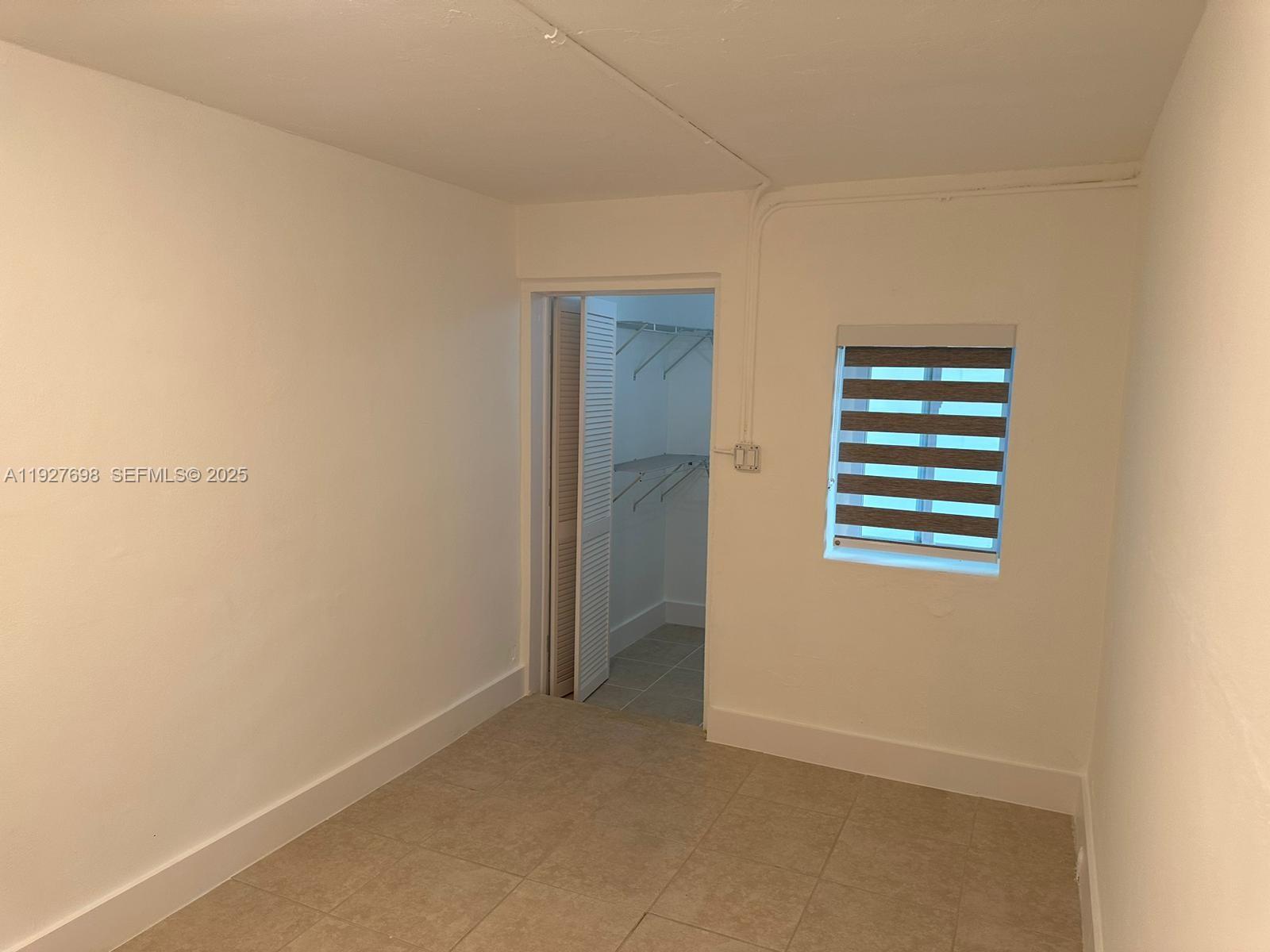 7071 Southwest 4th Street, Unit 2 Miami, FL 33144 - Photo 19 of 27 a view of an empty room with a window