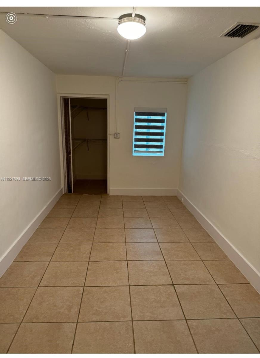 7071 Southwest 4th Street, Unit 2 Miami, FL 33144 - Photo 23 of 27 a view of an empty room with a window