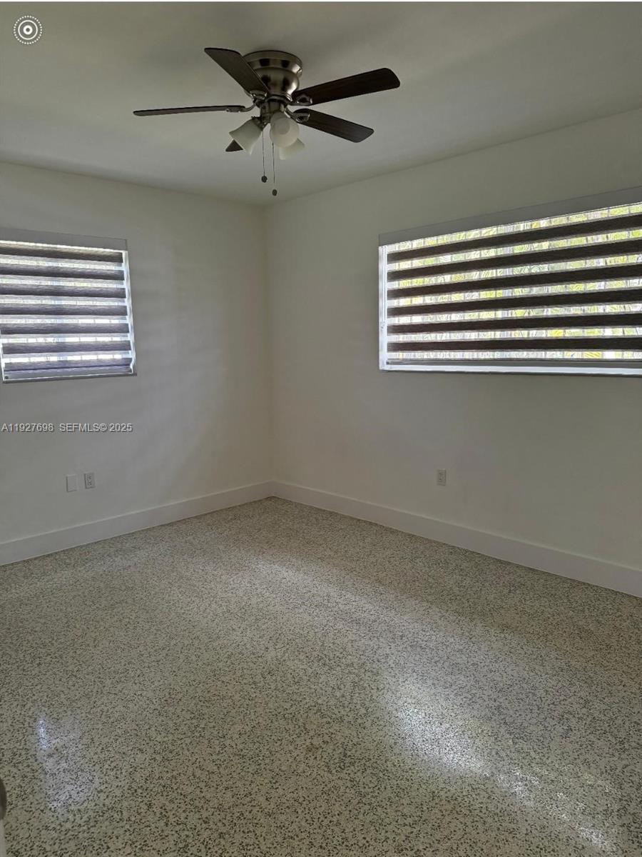 7071 Southwest 4th Street, Unit 2 Miami, FL 33144 - Photo 24 of 27 en empty room with windows and fan