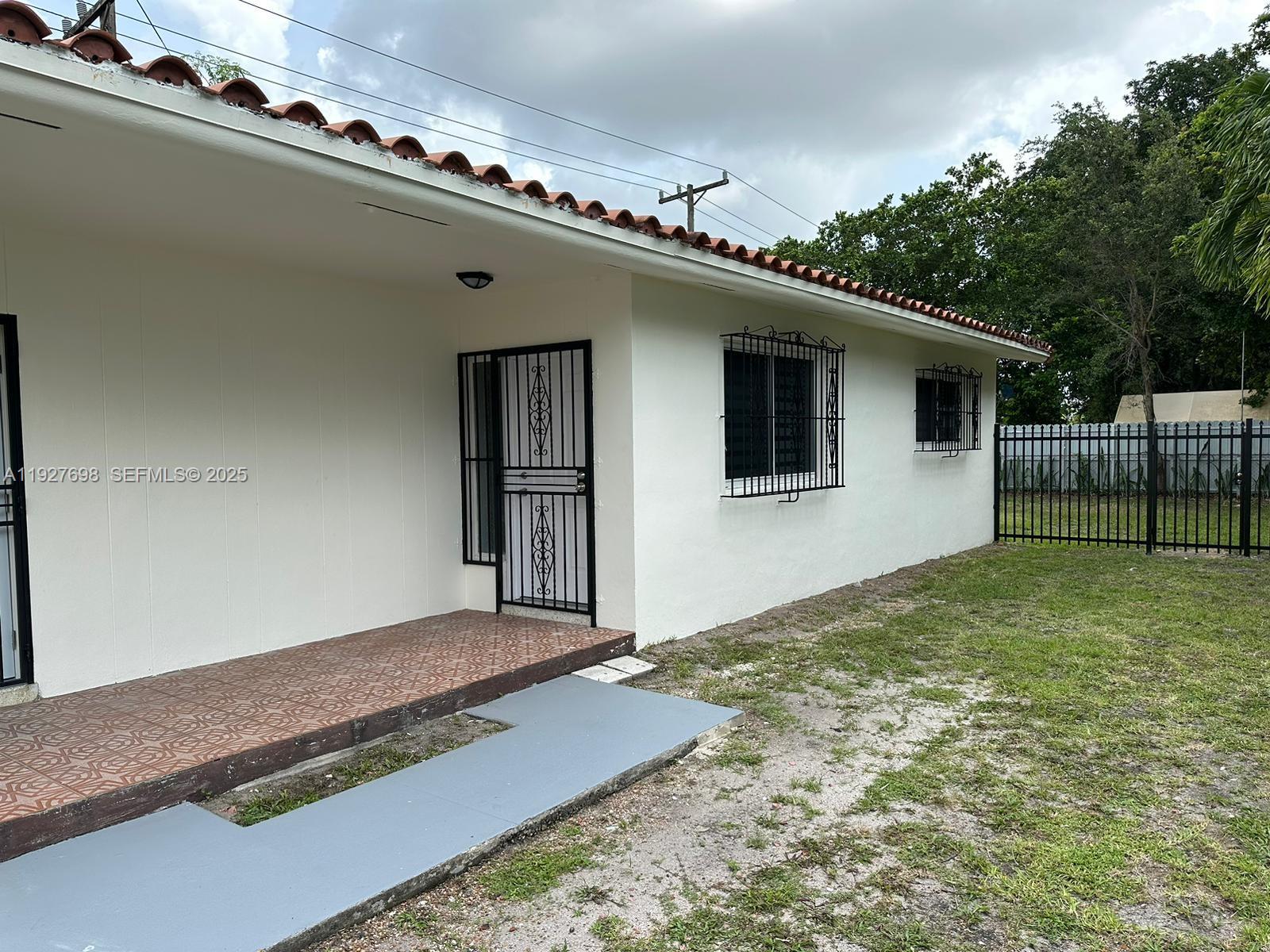 7071 Southwest 4th Street, Unit 2 Miami, FL 33144 - Photo 3 of 27 a view of an house with backyard and kitchen
