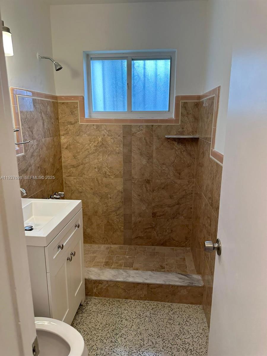 7071 Southwest 4th Street, Unit 2 Miami, FL 33144 - Photo 9 of 27 a bathroom with a sink a toilet and shower