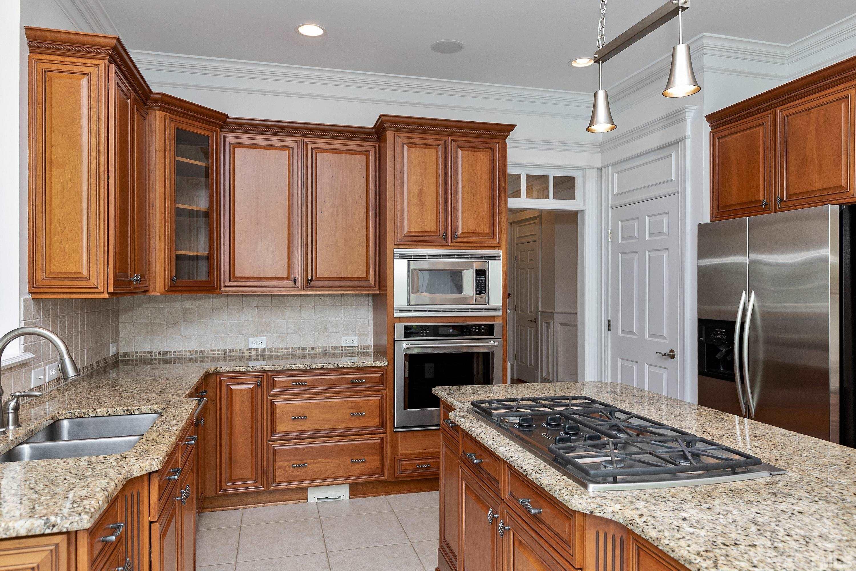 202 Simerville Road Chapel Hill, NC 27517 - Photo 19 of 51 a kitchen with stainless steel appliances granite countertop a stove refrigerator and cabinets