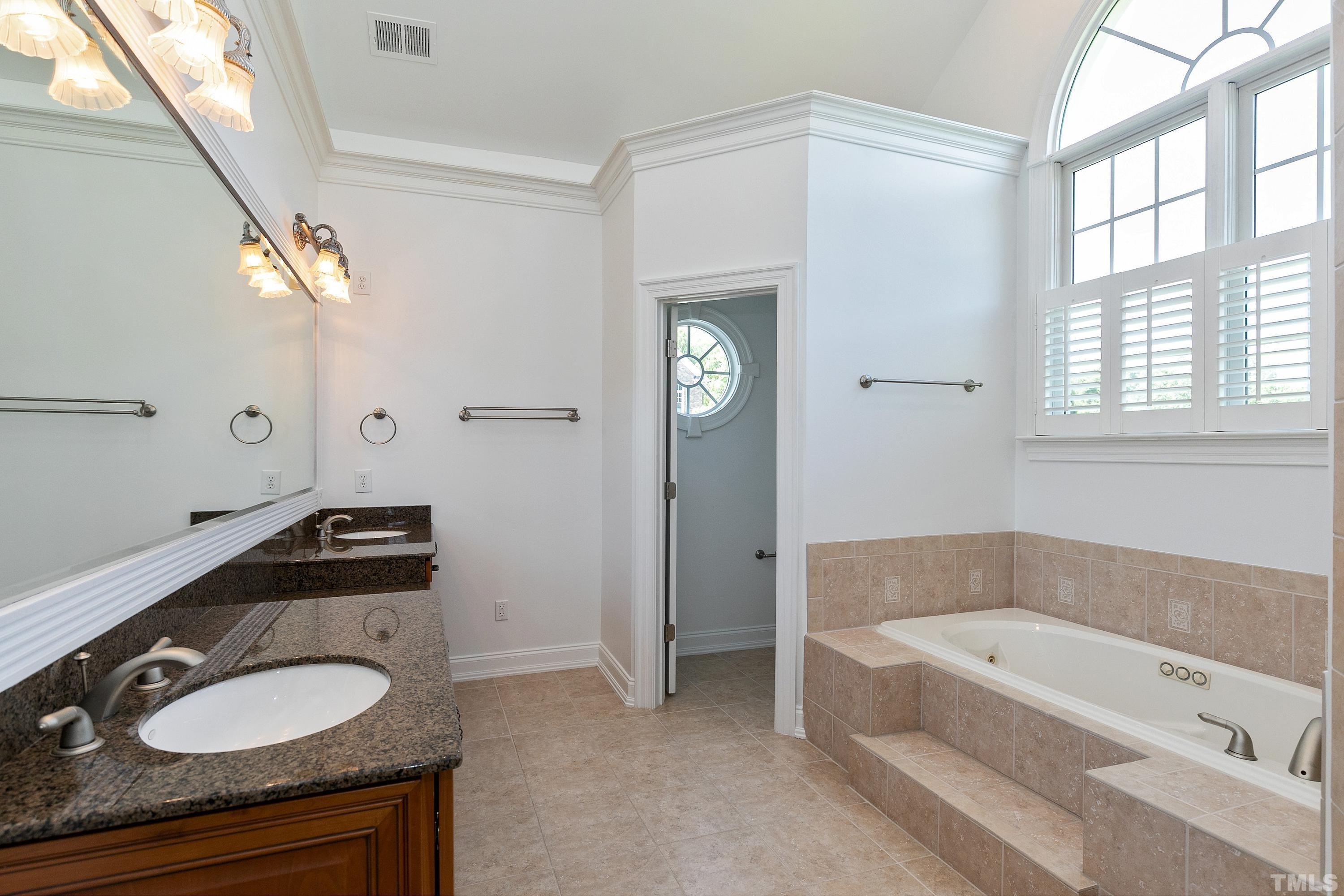 202 Simerville Road Chapel Hill, NC 27517 - Photo 27 of 51 a bathroom with a granite countertop tub sink and mirror