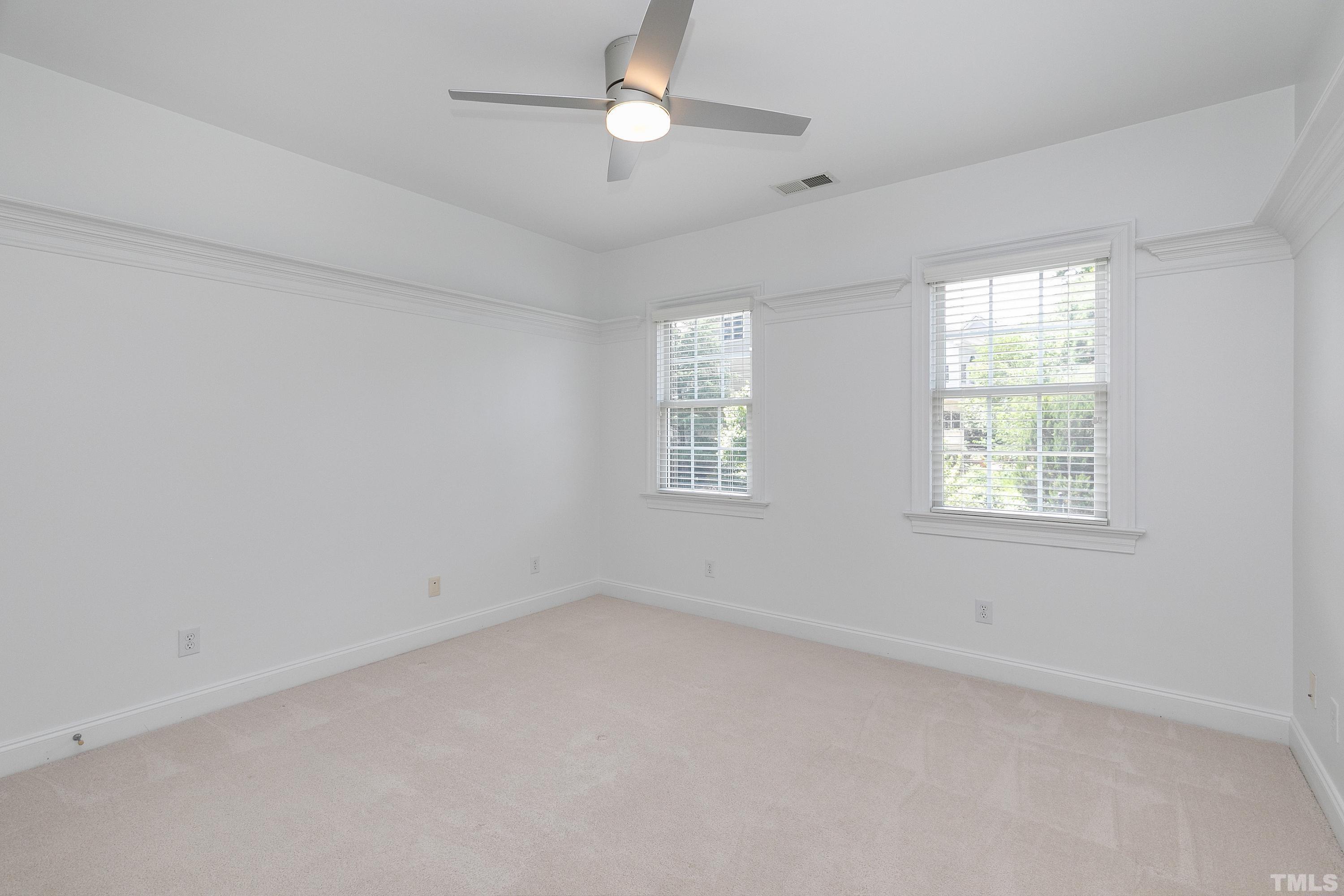 202 Simerville Road Chapel Hill, NC 27517 - Photo 36 of 51 an empty room with a window and ceiling fan