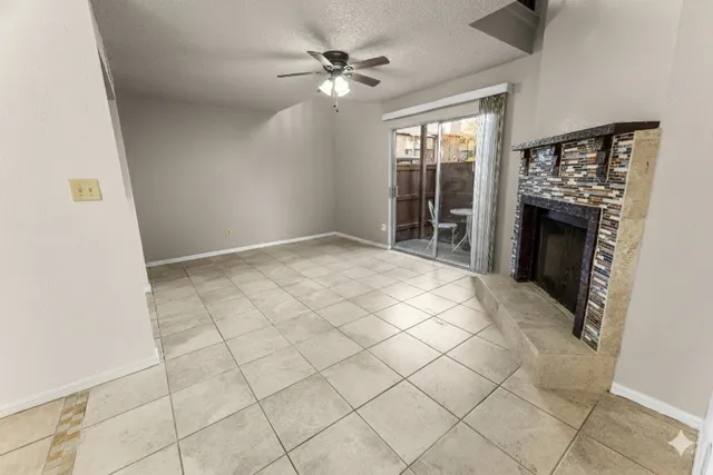 a view of an empty room with a fireplace