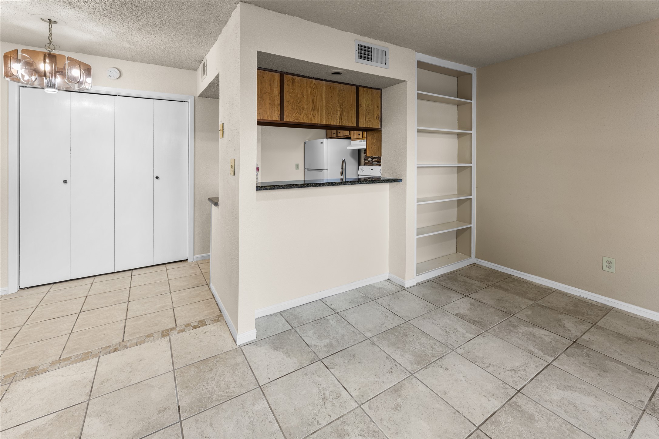 1500 Bay Area Boulevard, Unit 138 Houston, TX 77058 - Photo 6 of 13 a view of a kitchen with white cabinets and refrigerator
