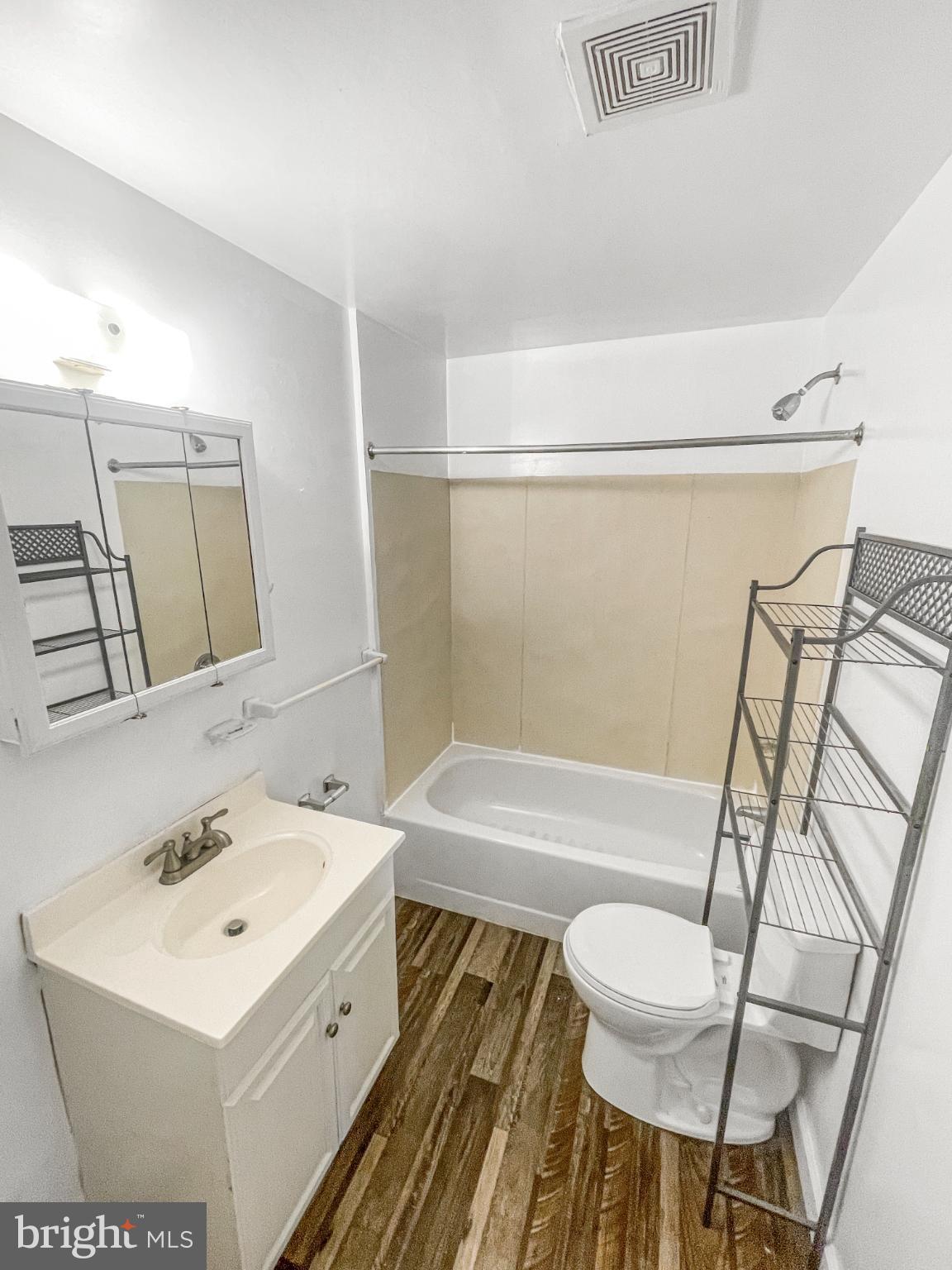 1436 Light Street Baltimore, MD 21230 - Photo 11 of 21 a bathroom with a sink mirror vanity and toilet