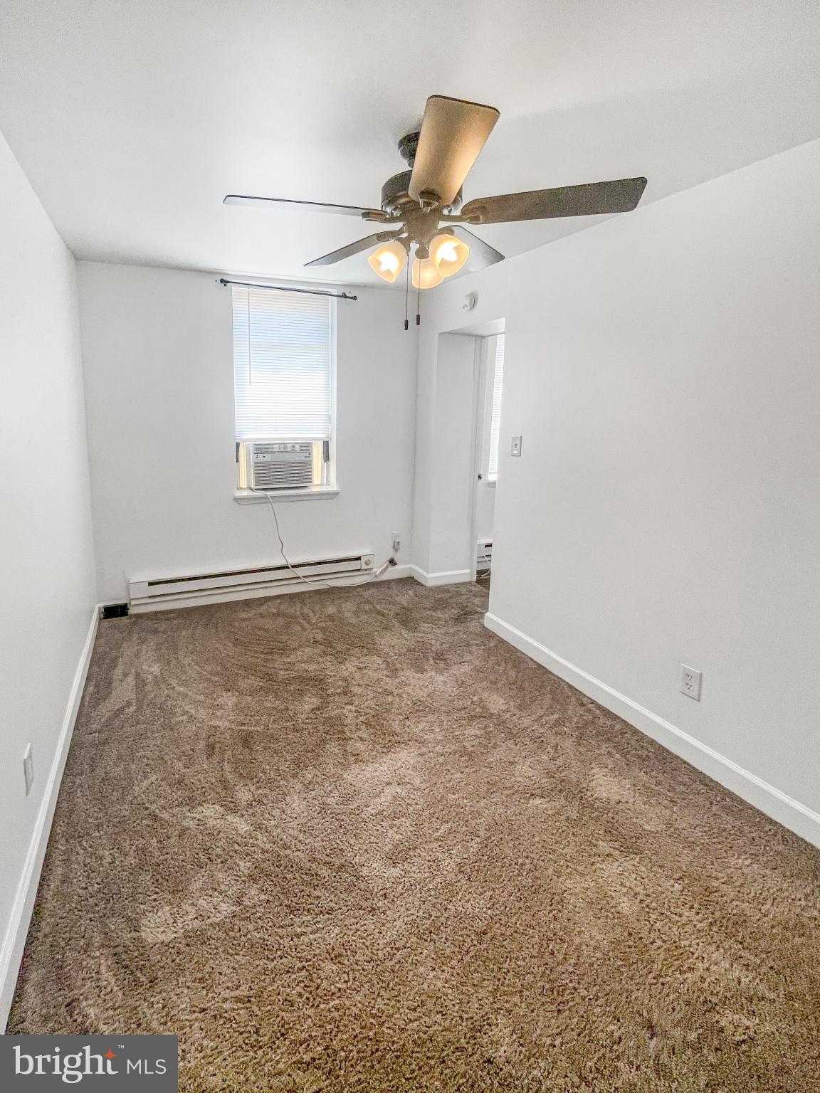 1436 Light Street Baltimore, MD 21230 - Photo 13 of 21 an empty room with a ceiling fan and window