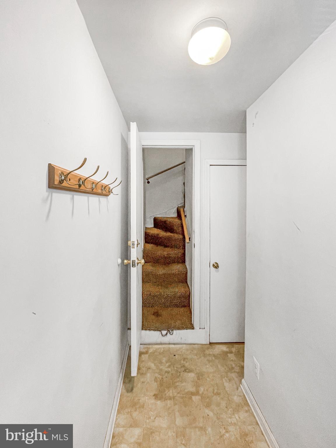 1436 Light Street Baltimore, MD 21230 - Photo 16 of 21 an empty room with a door and wooden floor