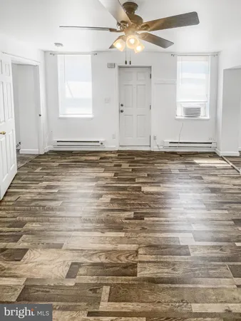 a view of a room with wooden floor