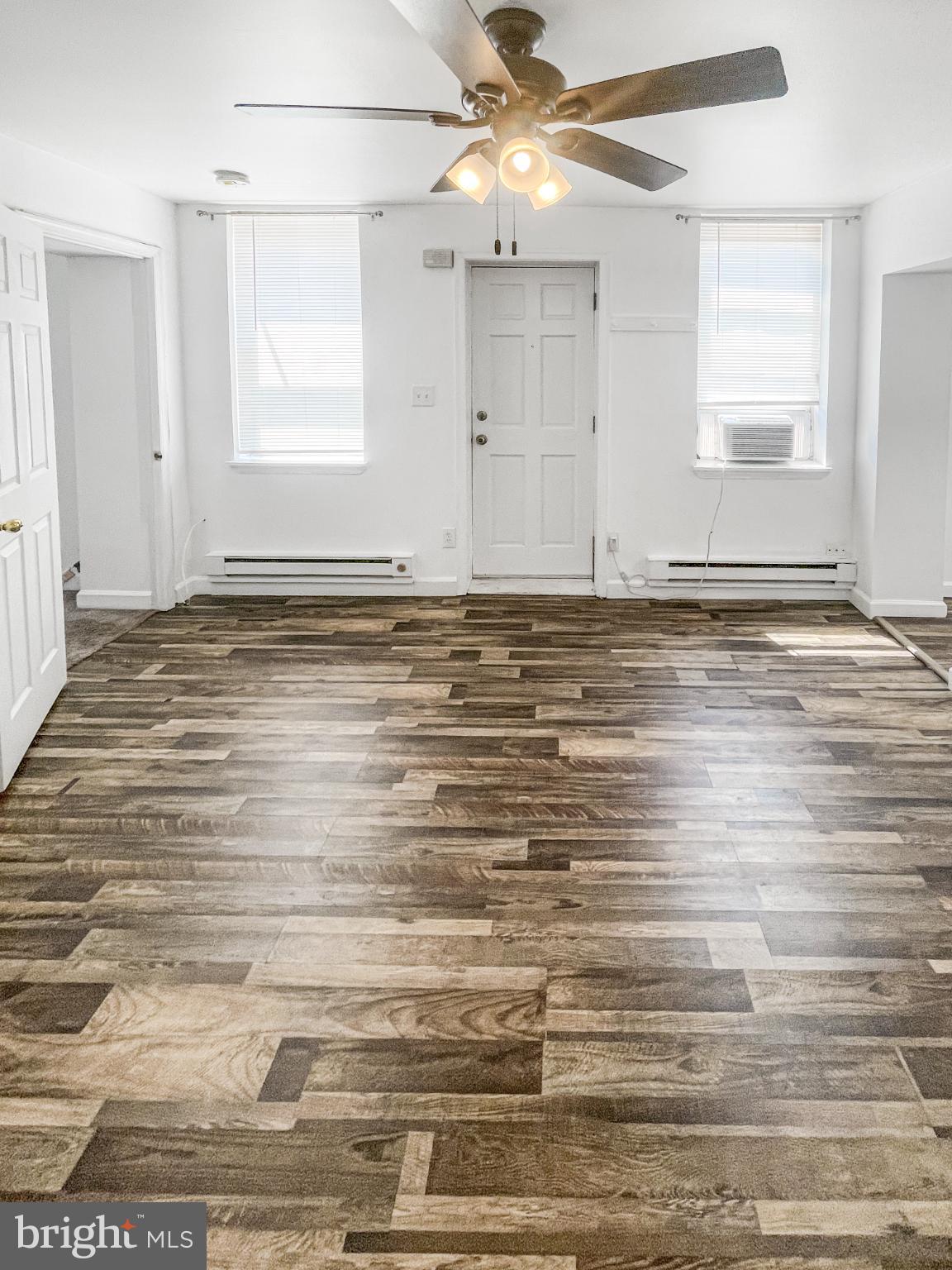 1436 Light Street Baltimore, MD 21230 - Photo 8 of 21 an empty room with wooden floor fan and windows