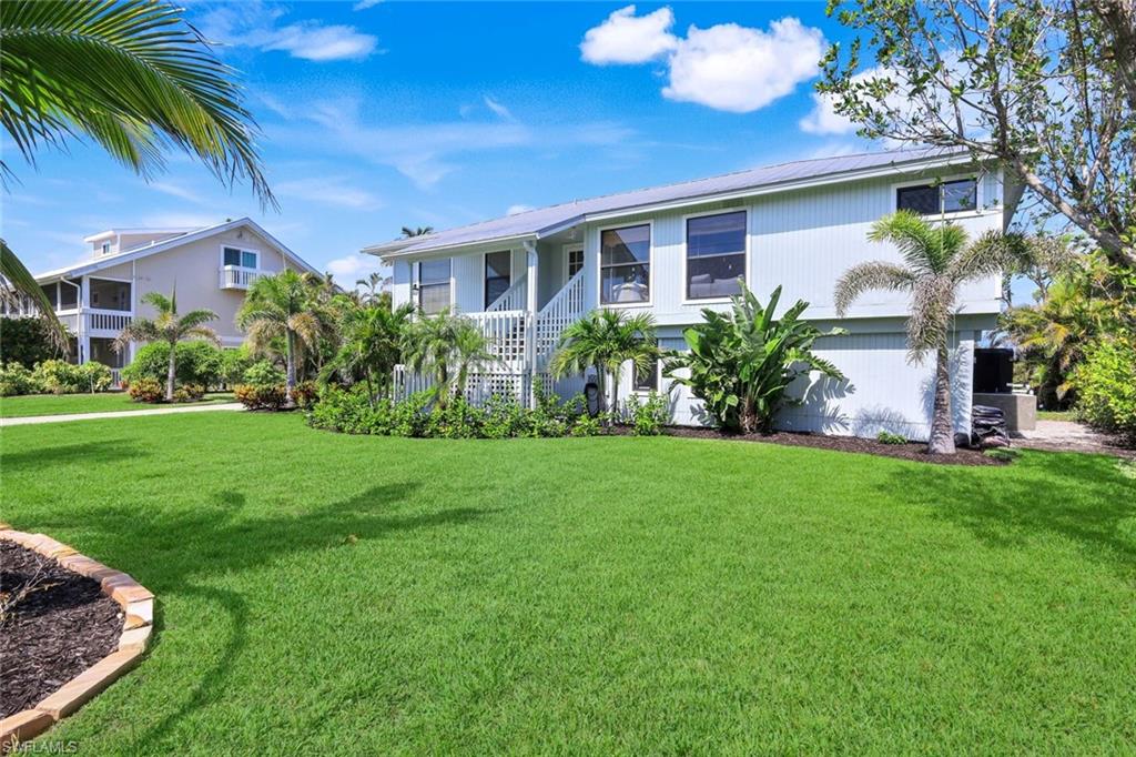 647 Rabbit Road Sanibel, FL 33957 - Photo 33 of 45 a front view of a house with garden