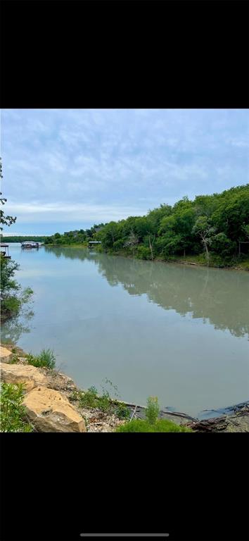 a view of a lake with beach and outdoor space