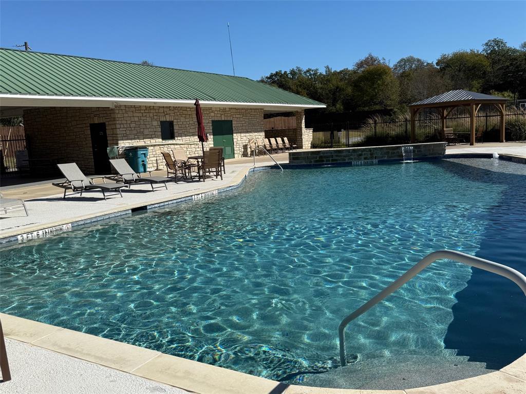 363 Three Forks Chico, TX 76431 - Photo 5 of 8 a view of a patio with table and chairs under an umbrella