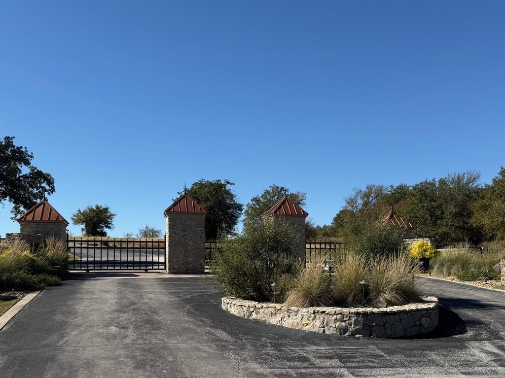 363 Three Forks Chico, TX 76431 - Photo 8 of 8 a view of a street with a bench in front of it