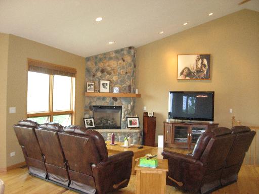 2704 Rolling Oaks Road Spring Grove, IL 60081 - Photo 3 of 16 a living room with fireplace furniture and a flat screen tv