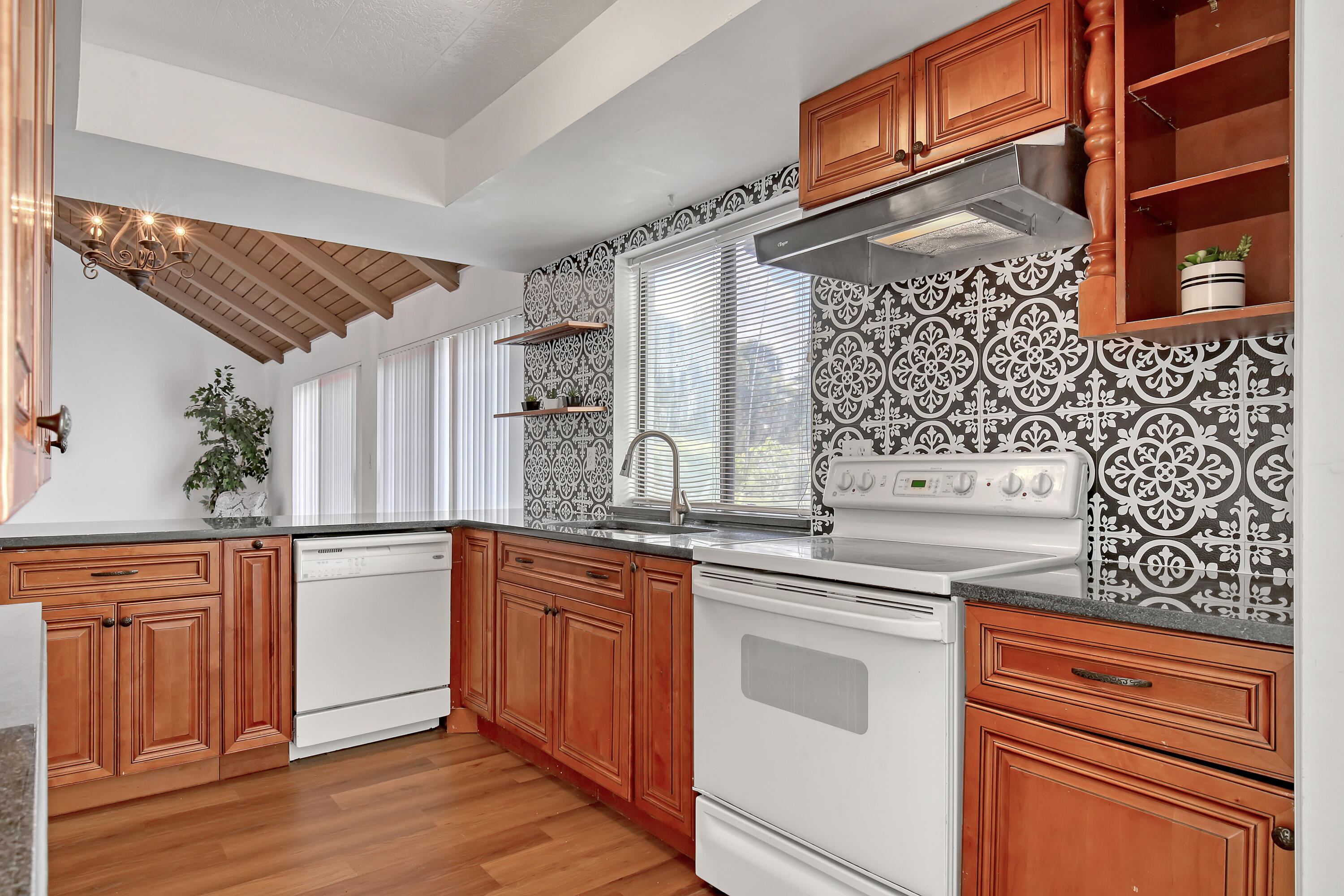 241 Northwest 15th Street Boca Raton, FL 33432 - Photo 13 of 34 a kitchen with stainless steel appliances granite countertop a stove and a sink