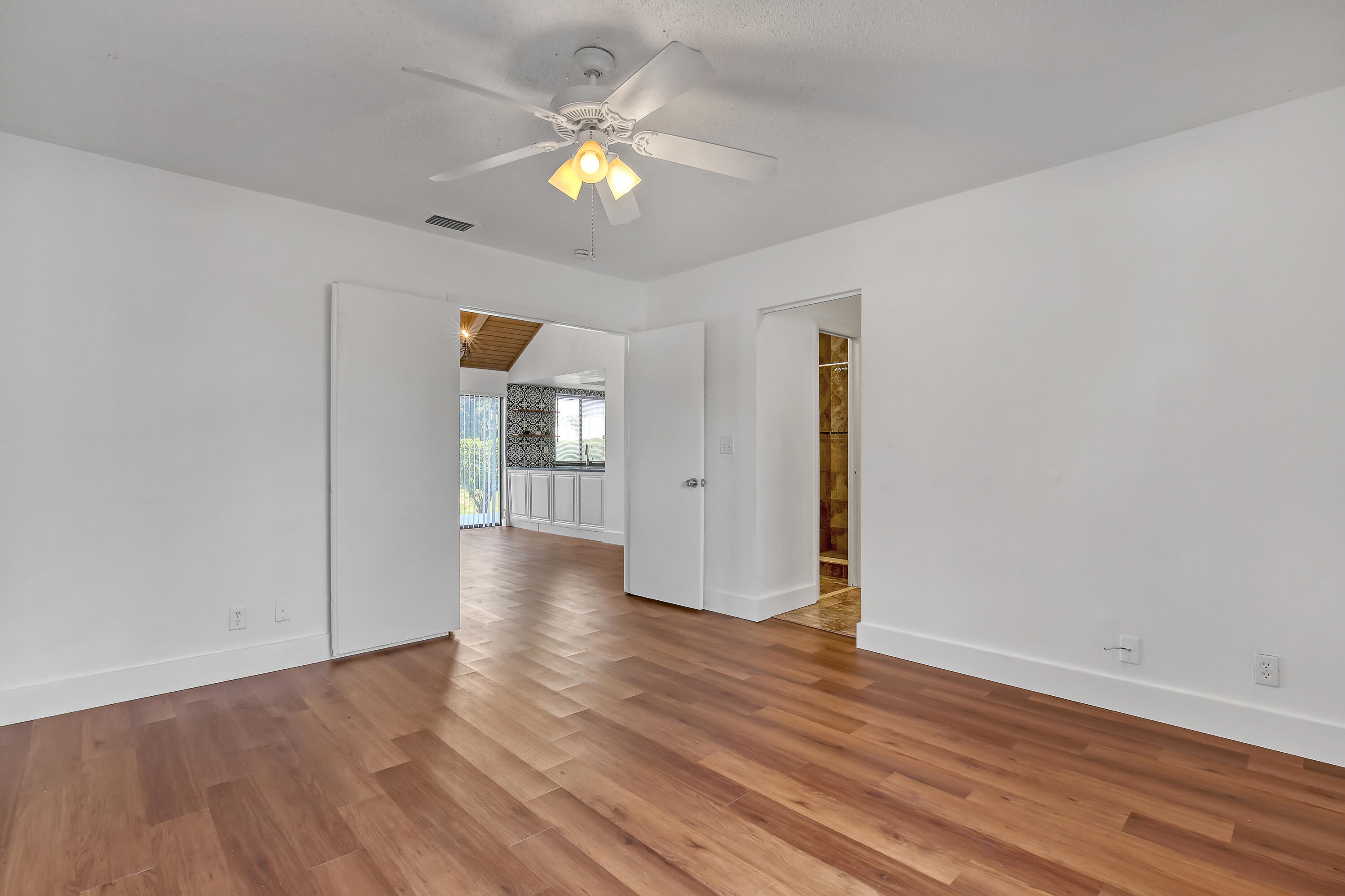 241 Northwest 15th Street Boca Raton, FL 33432 - Photo 22 of 34 wooden floor in an empty room with a window