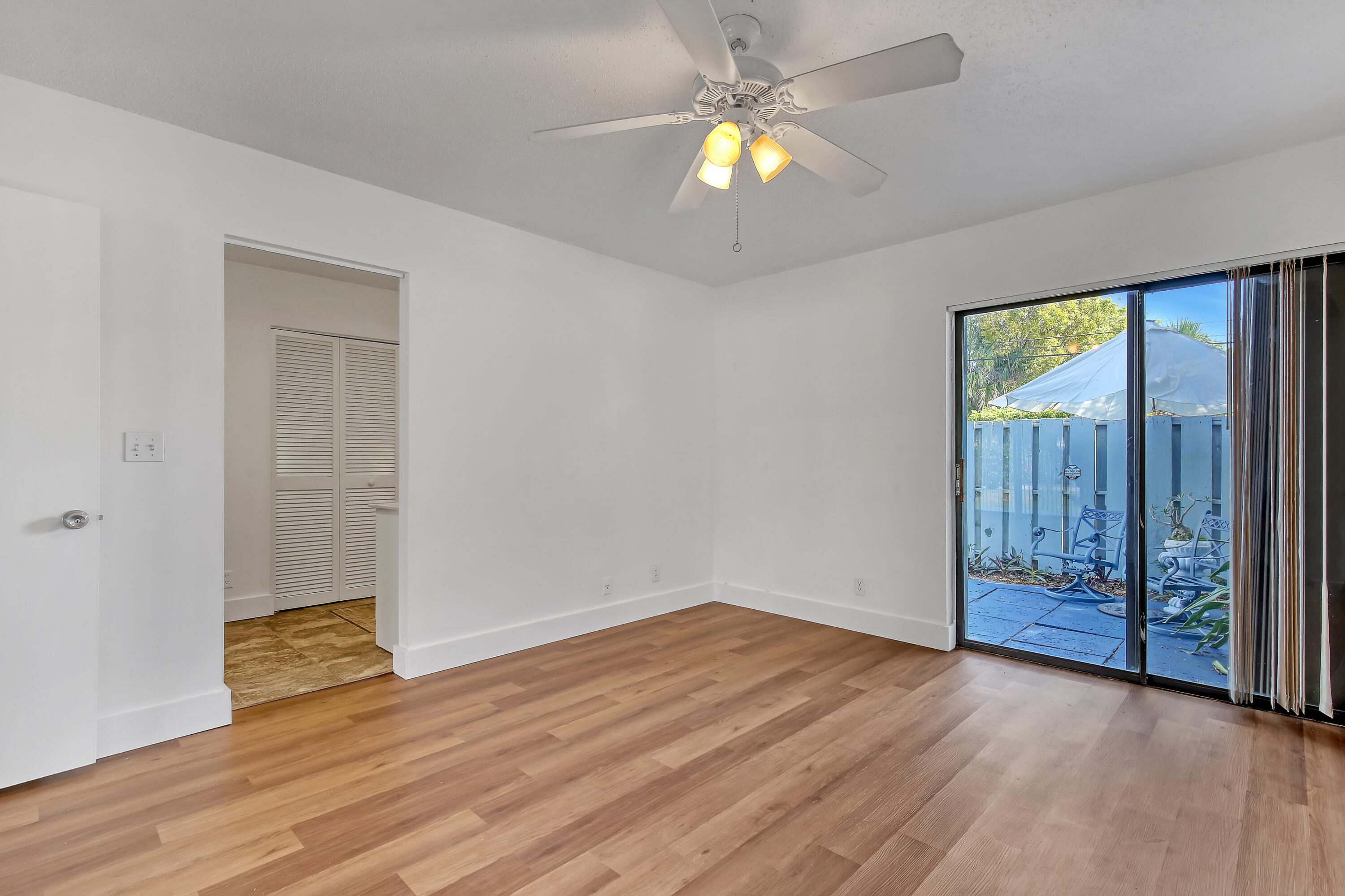 241 Northwest 15th Street Boca Raton, FL 33432 - Photo 23 of 34 an empty room with wooden floor and windows