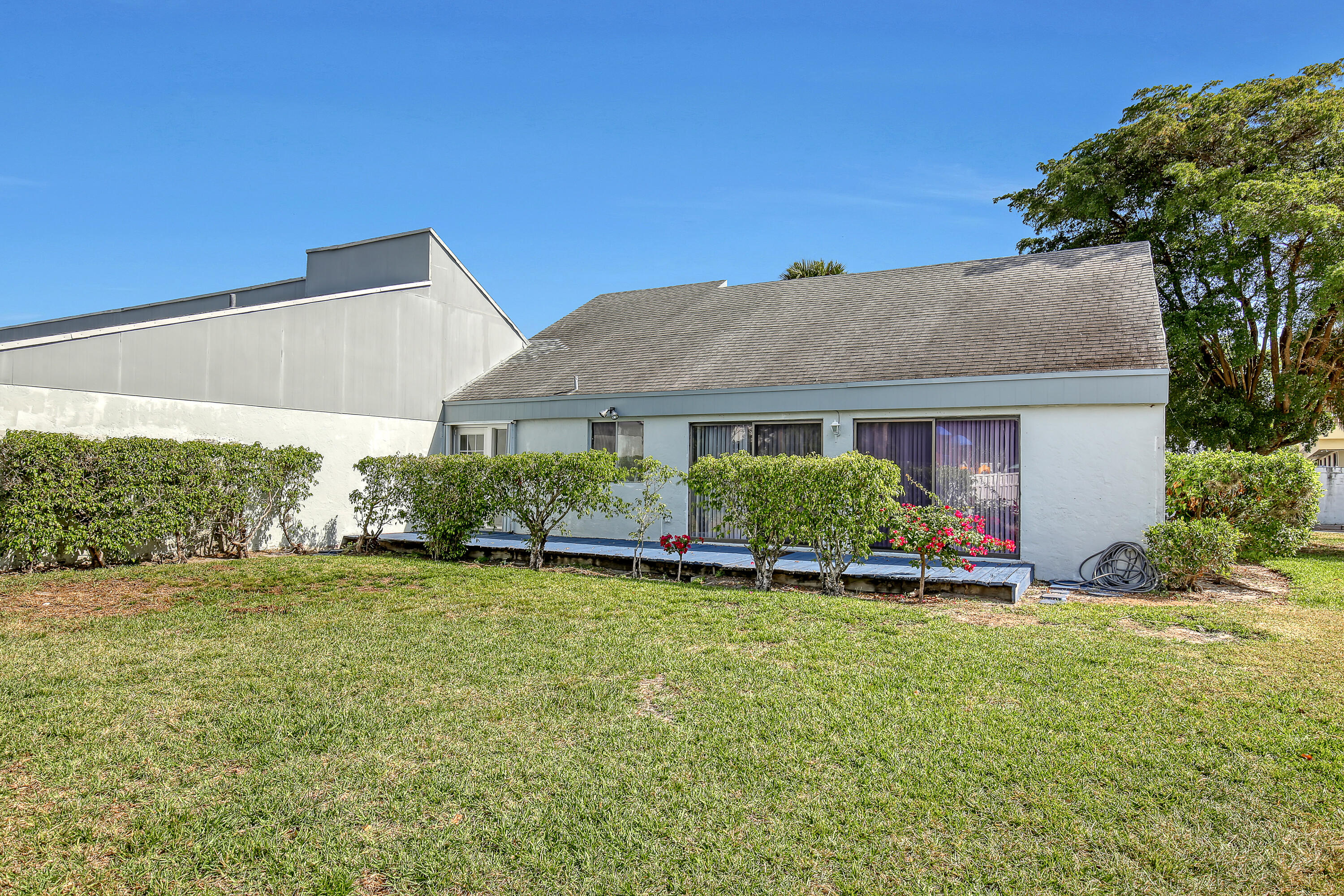 241 Northwest 15th Street Boca Raton, FL 33432 - Photo 33 of 34 a front view of a house with a yard and garage